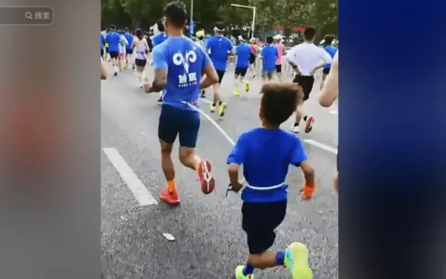 Buộc dây kéo con trai 9 tuổi chạy half marathon